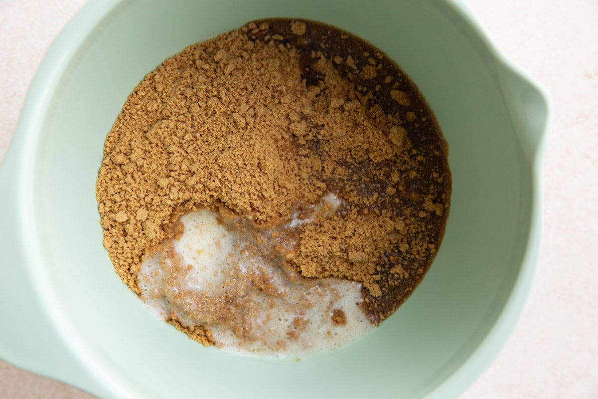 Ingredients for graham cracker crust in a mixing bowl.