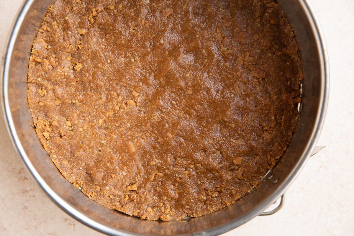 Graham cracker crust mixture pressed into a 9-inch cake pan.