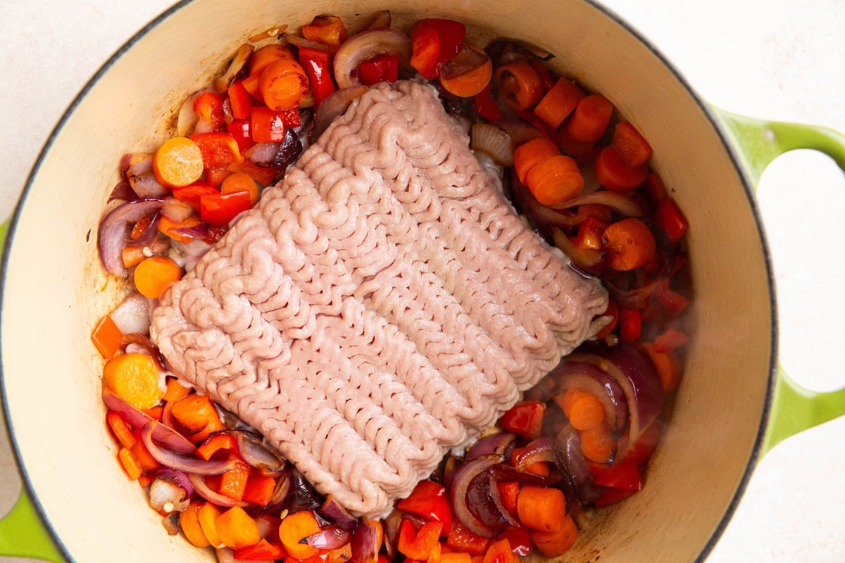 Ground turkey added to the pot with the vegetables.