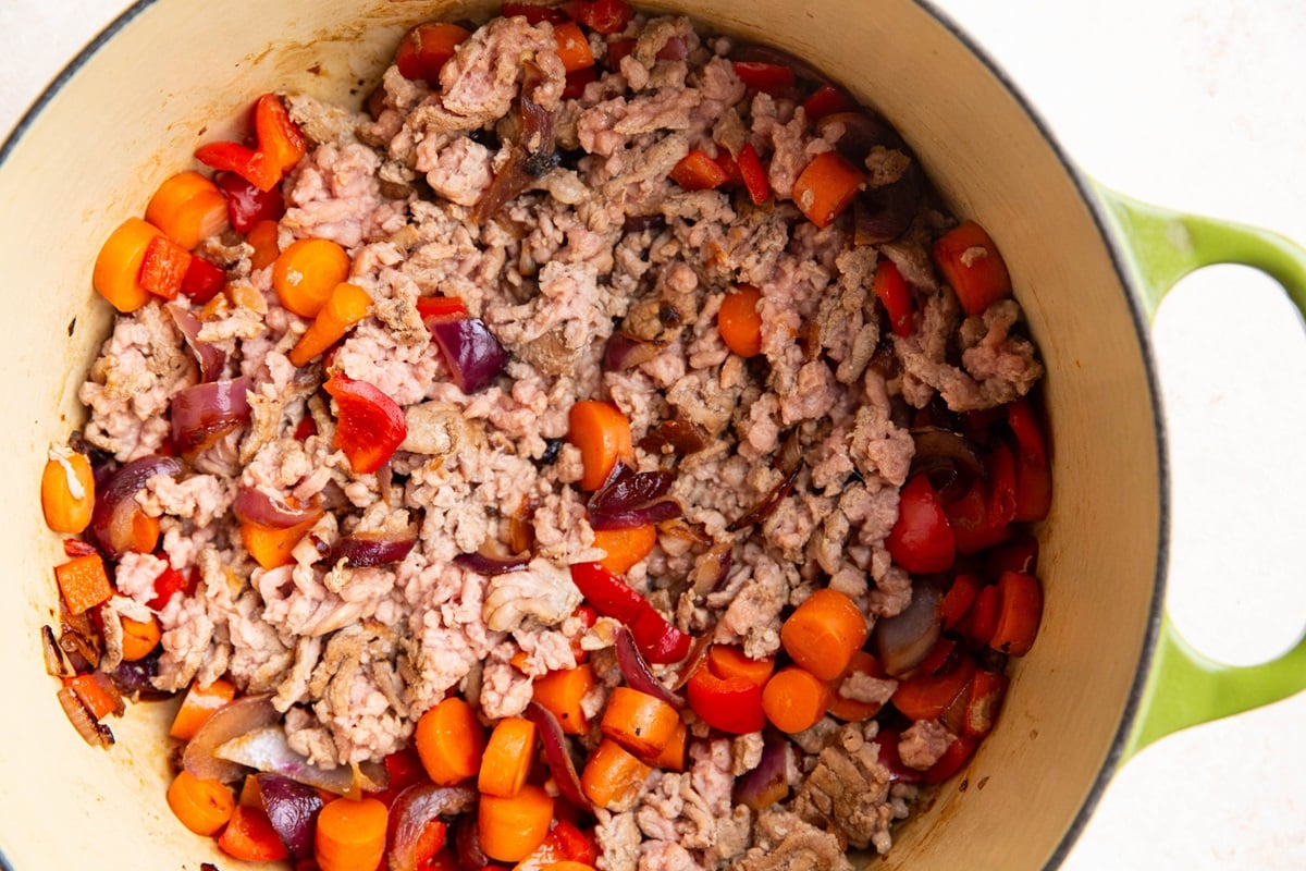 Ground turkey and vegetables cooking in a pot.