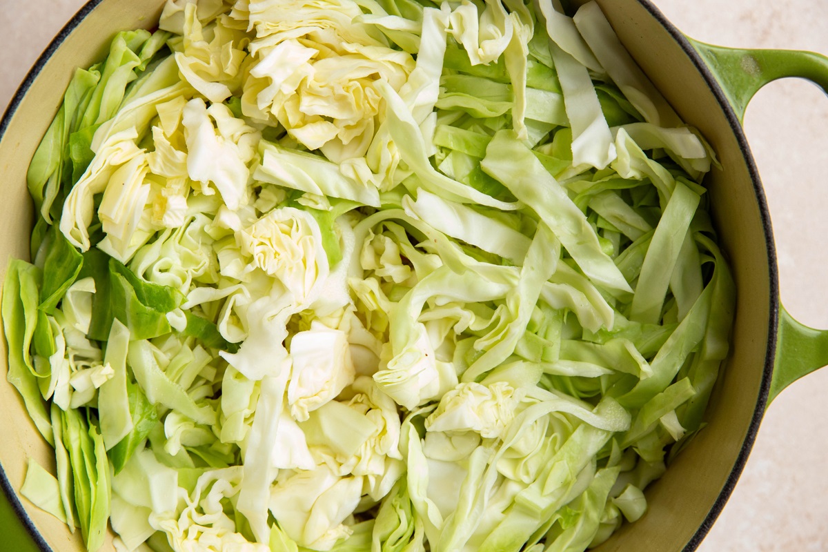 Thinly sliced cabbage in a large pot.