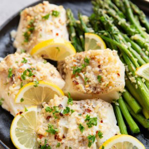 Garlic butter cod on a plate, ready to serve.