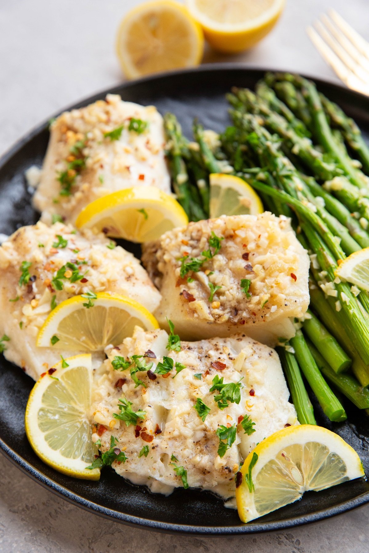 Garlic butter cod on a plate, ready to serve.