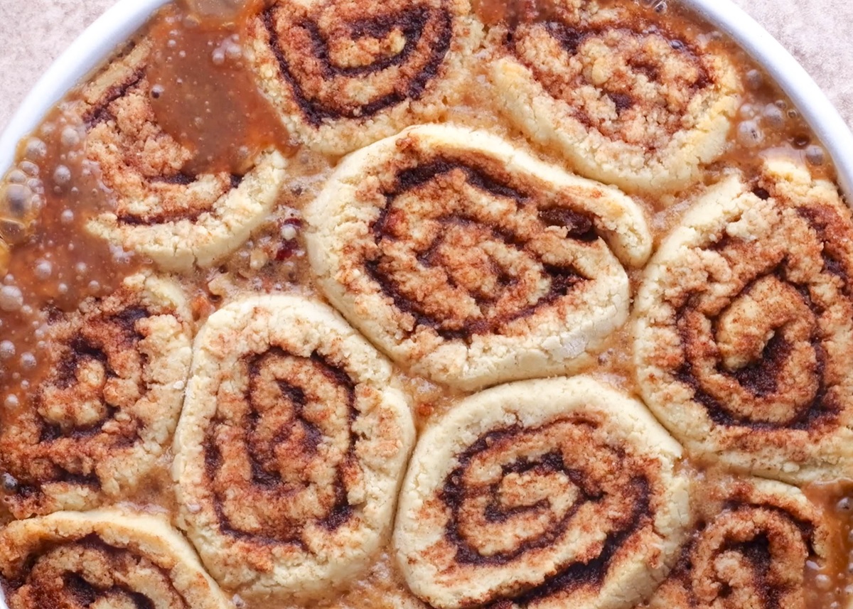 Freshly baked cinnamon rolls, fresh out of the oven in a cake pan.