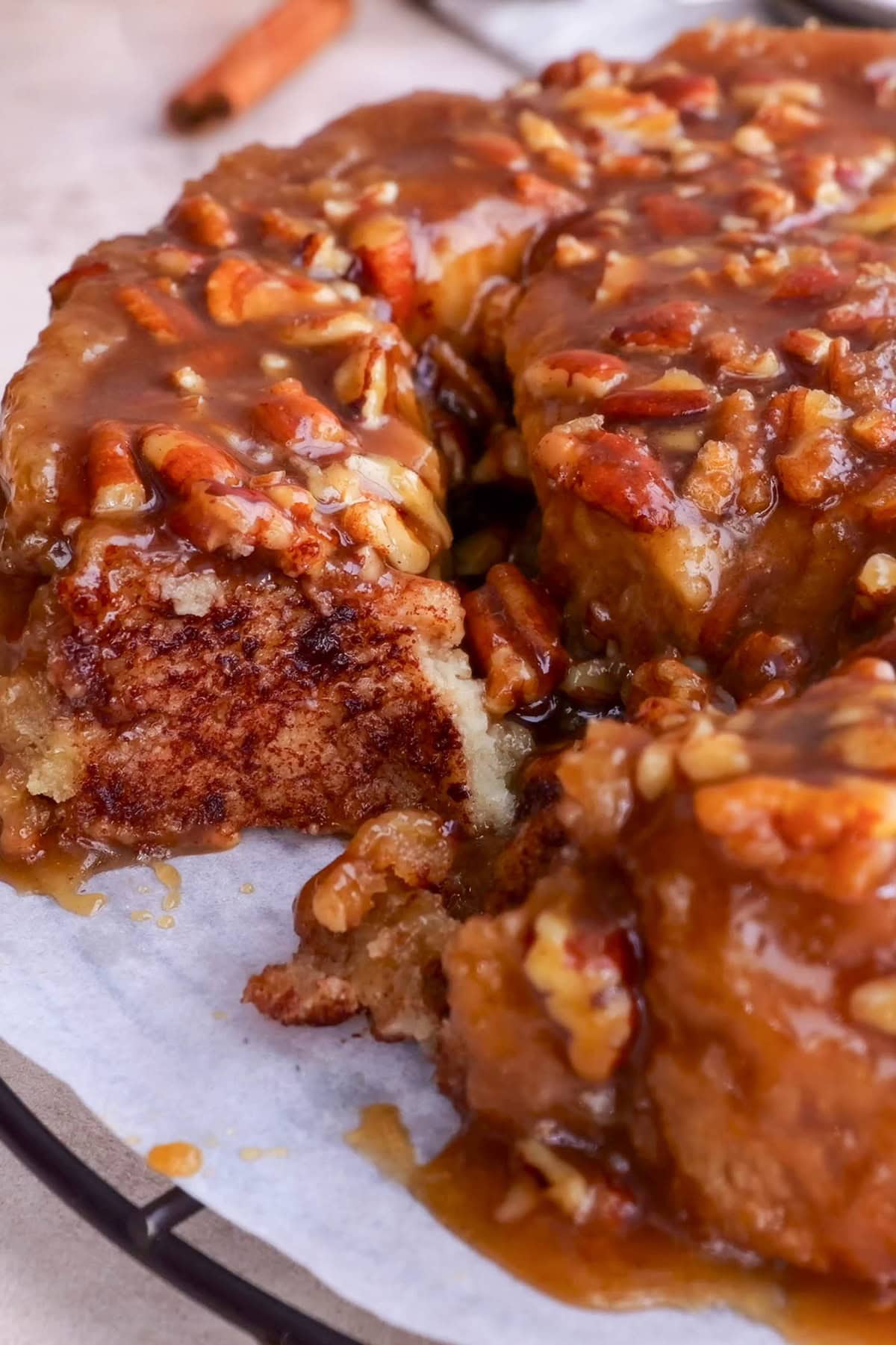 Pecan sticky buns with one bun taken out.