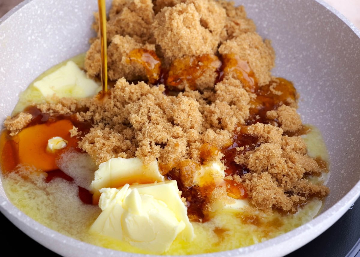 Skillet with butter, brown sugar, pure maple syrup melting inside to make caramel.