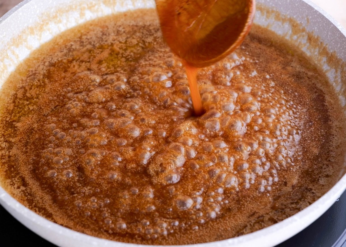 Boiling caramel in a skillet.