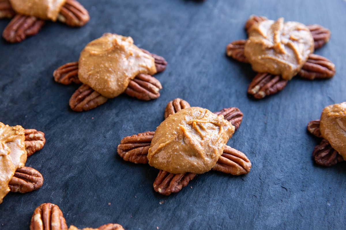 Pecan turtles with the peanut butter layer on top.