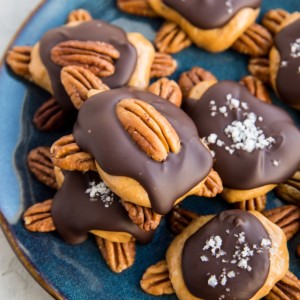 Pecan turtle candy on a blue plate, ready to serve