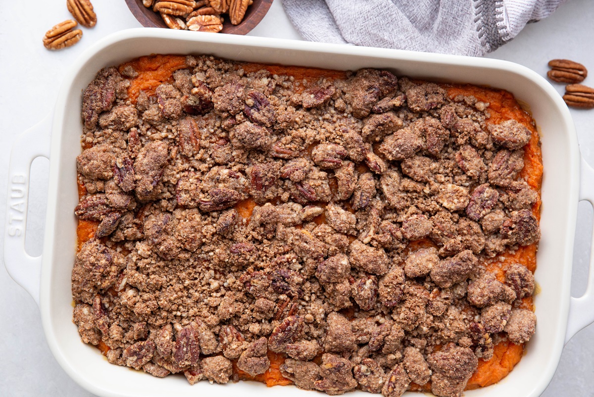 Casserole dish fresh out of the oven with pecan streusel sweet potato casserole. A classic recipe for the family favorite.