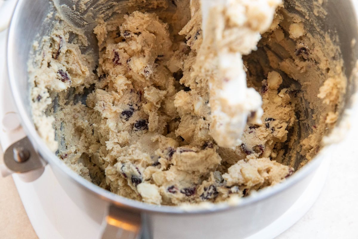 Finished white chocolate macadamia nut cookie dough in a stand mixer.