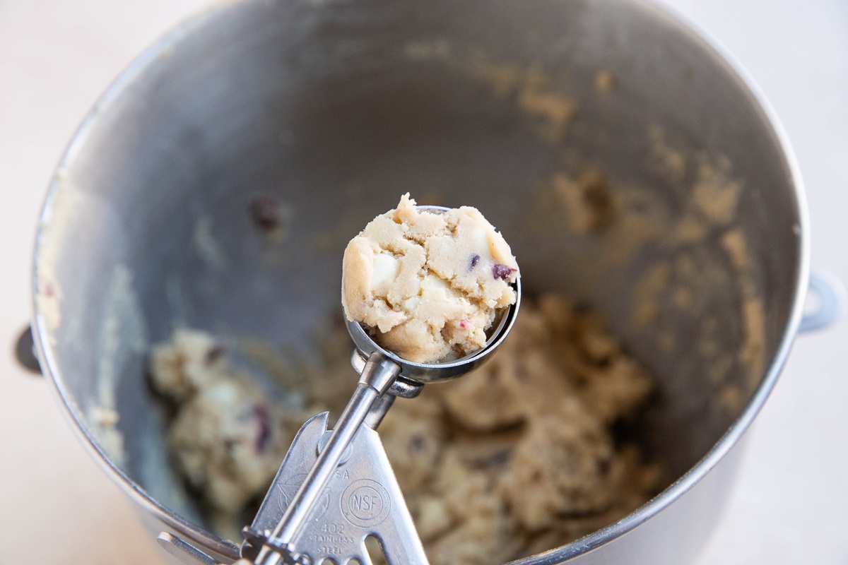 Cookie scoop with a scoop of cookie dough.