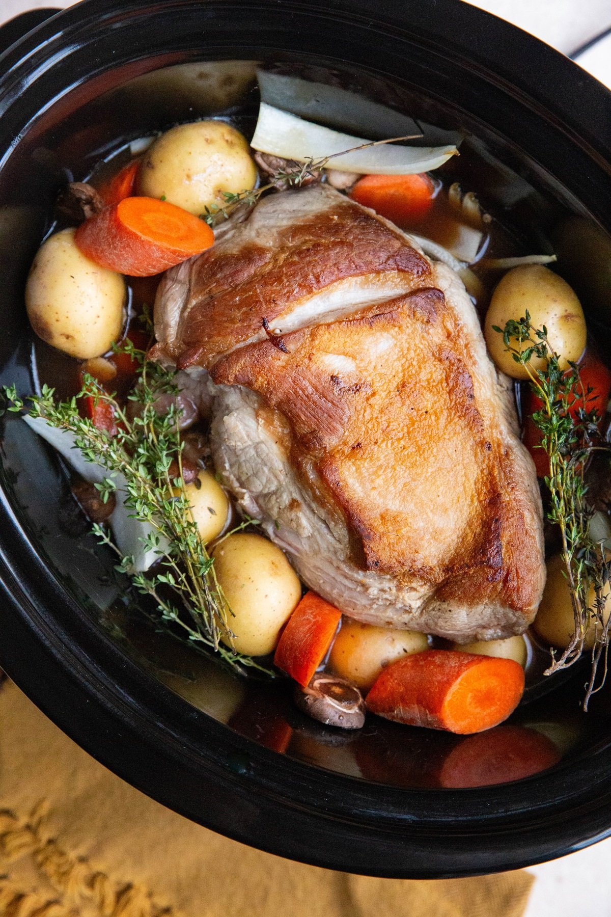 Pork roast and vegetables in a crock pot.