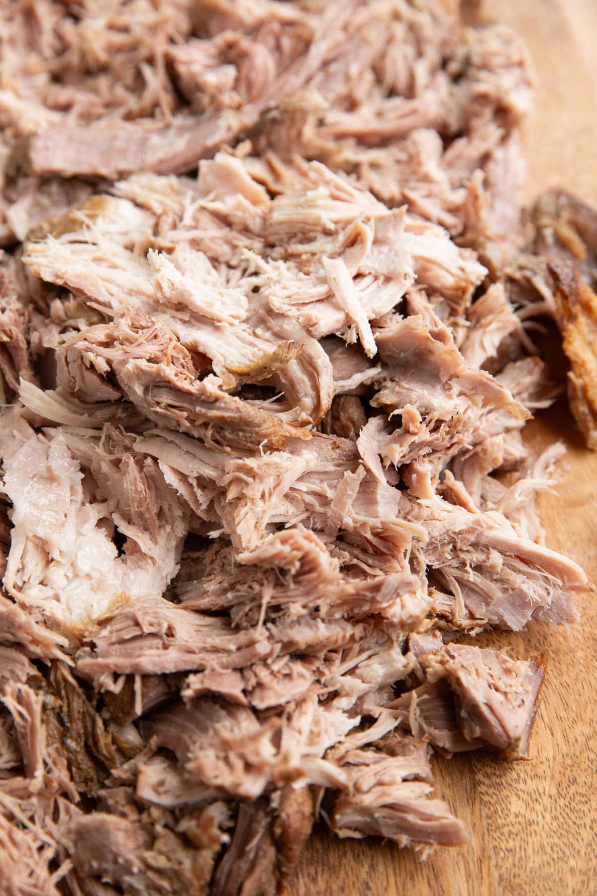 Shredded pork on a cutting board.