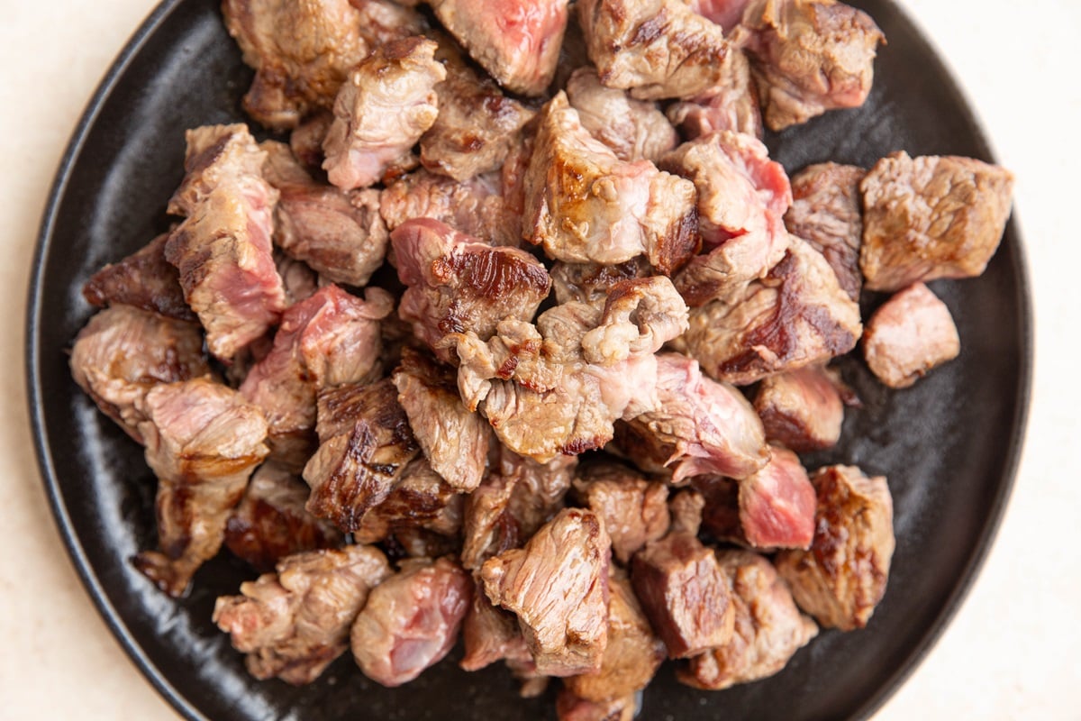 Beef stew meat on a plate, to be used in stew.