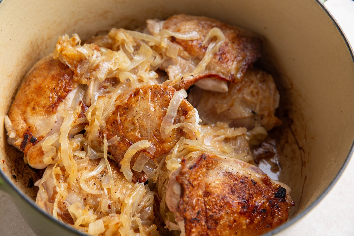 Caramelized onions and chicken in a Dutch oven.
