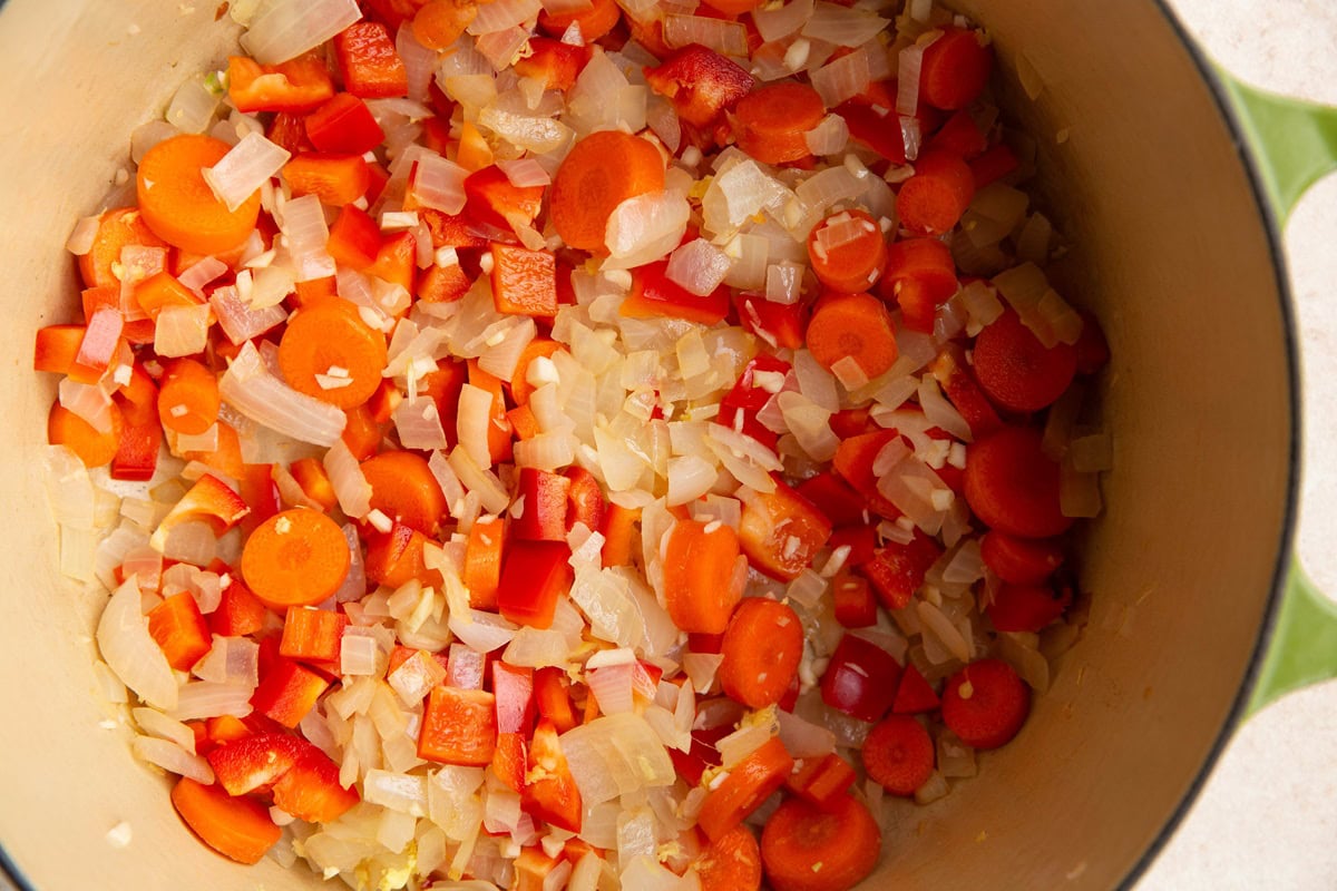 Vegetables cooking in a large pot for curry soup.