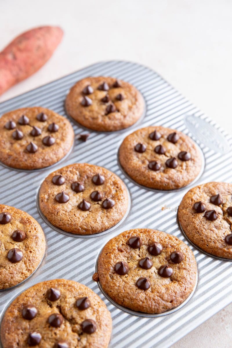 Sweet potato muffins in a muffin tray, fresh out of the oven.