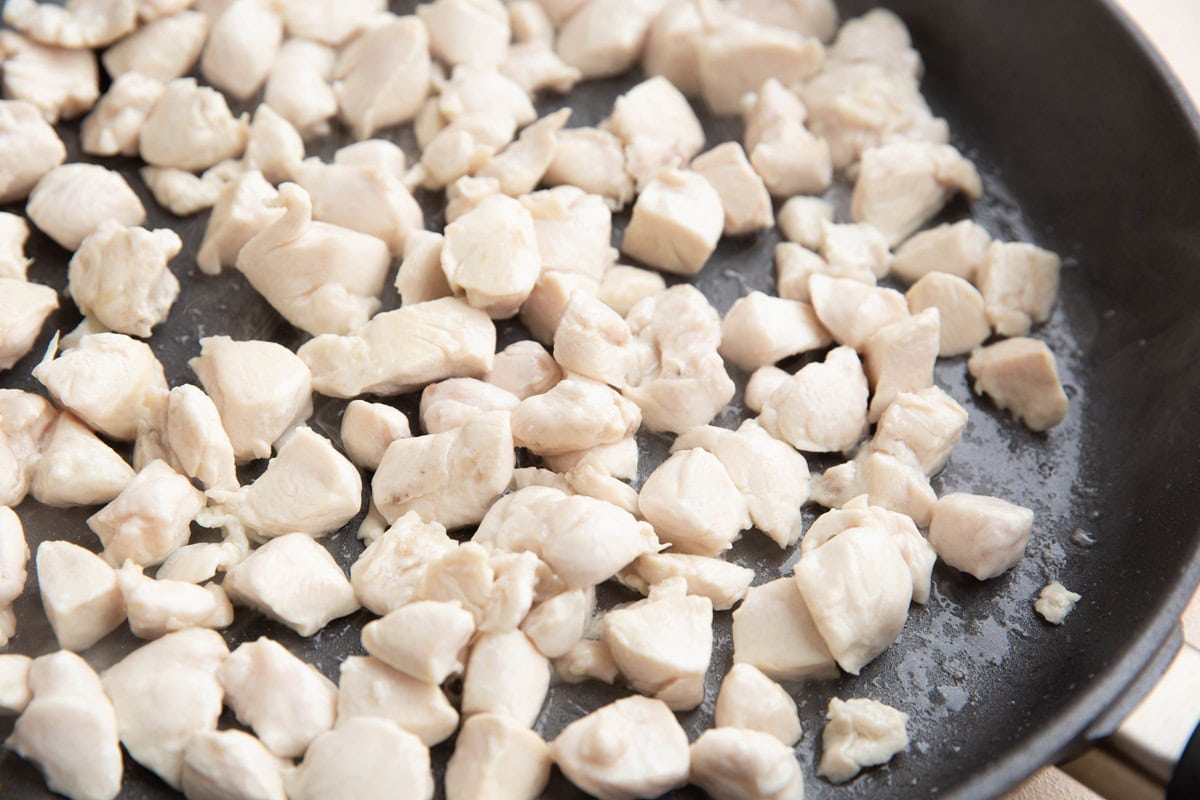 Chicken cooking in a skillet