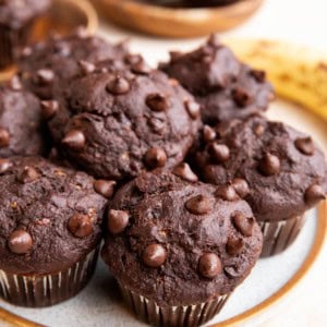 Plate full of chocolate chip oatmeal banana muffins.