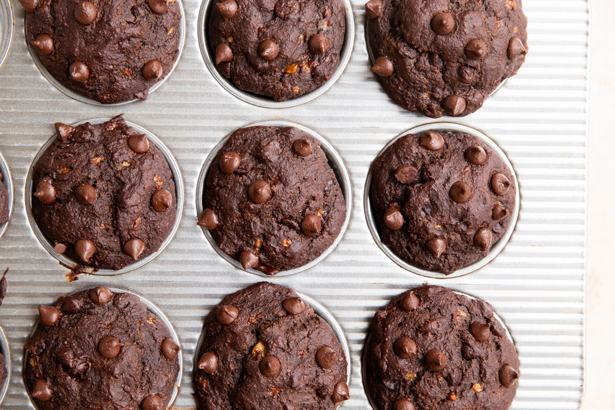Chocolate Oatmeal Banana Muffins in a muffin tray, fresh out of the oven.