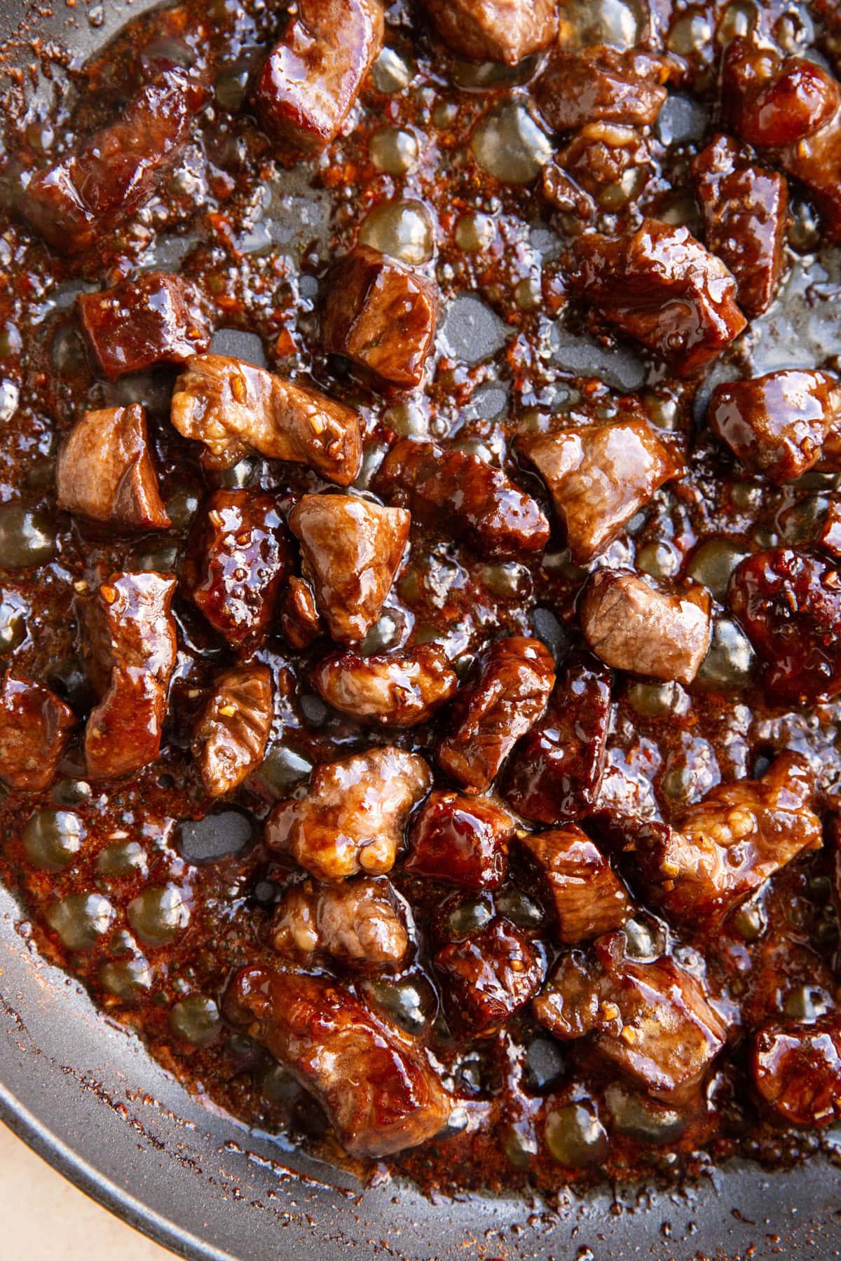 Skillet of sesame garlic steak bites, ready to eat.