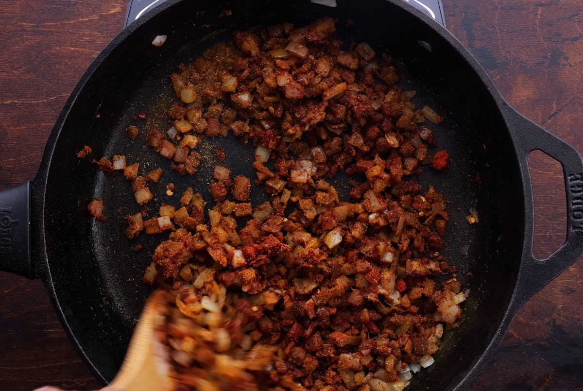 Skillet of onions and seasonings cooking.