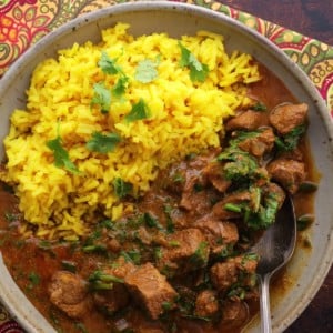 Big bowl of lamb curry with saffron rice.