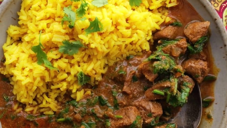 Big bowl of lamb curry with saffron rice.