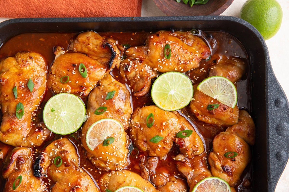 Large baking dish full of cooked Korean chicken.