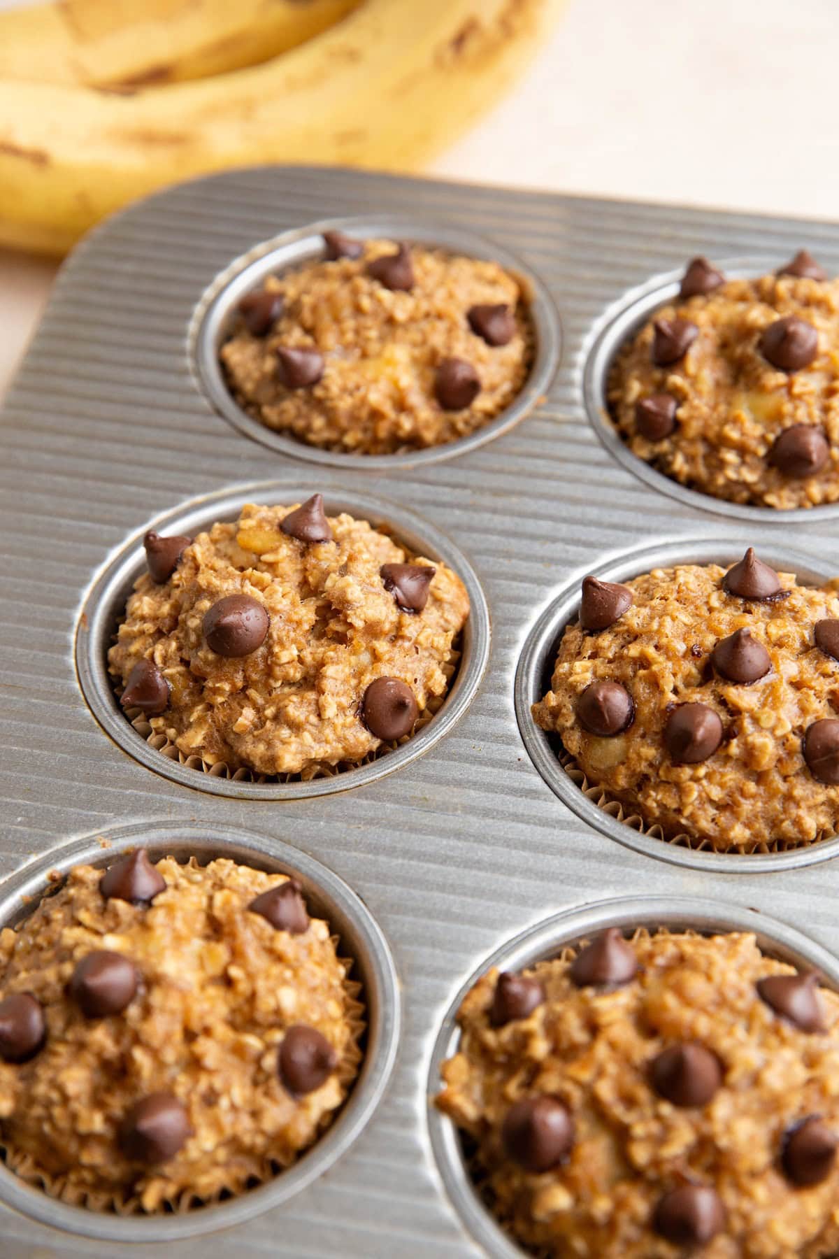 Muffin tray full of banana oatmeal muffins.