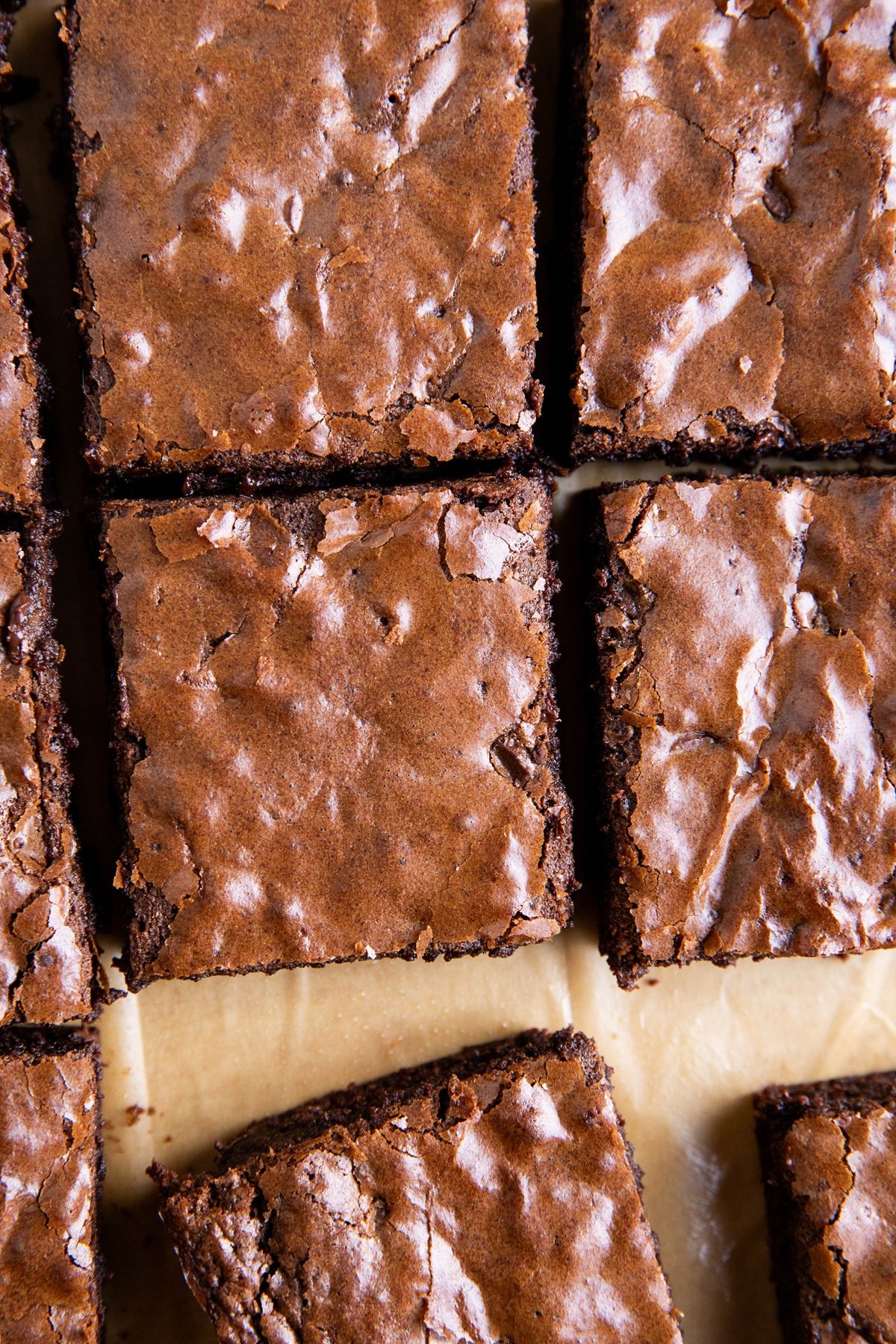 Gluten-free brownies with shiny crackle top, cut into slices.