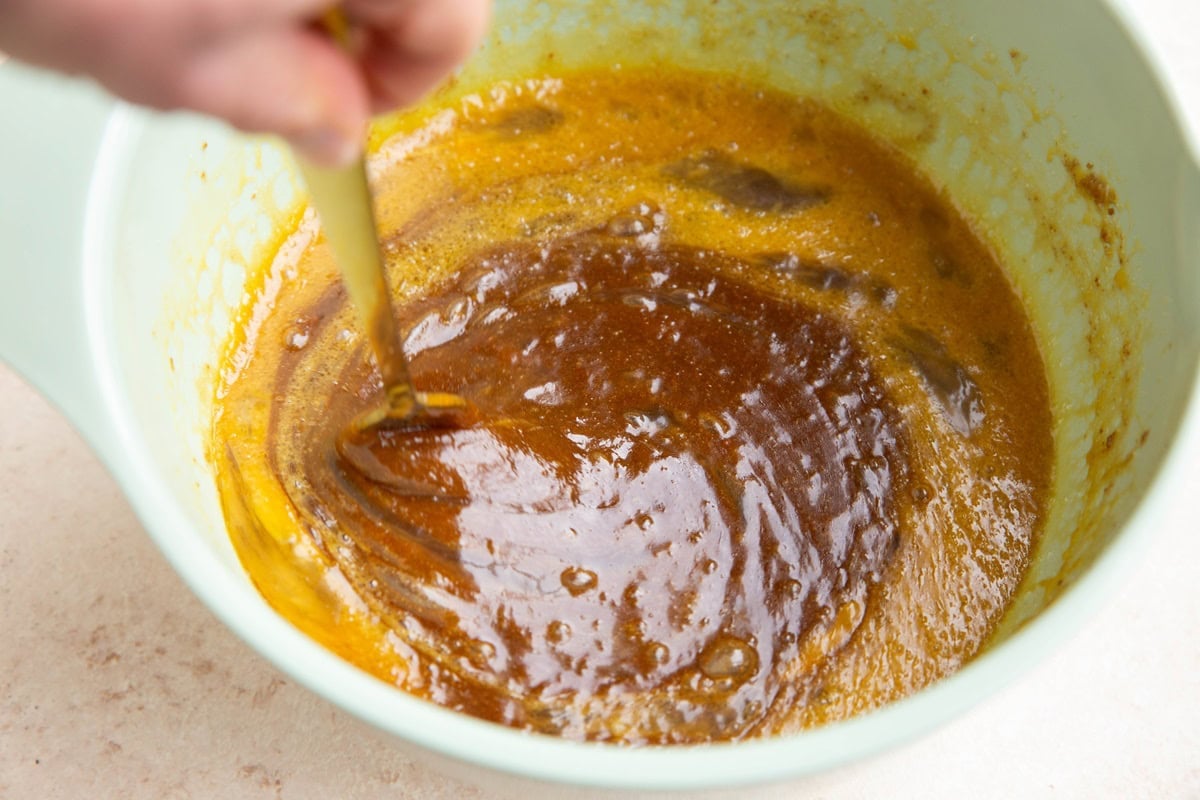 Mixing beaten eggs into the butter sugar mixture.