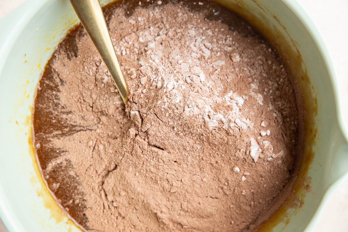 Dry ingredients on top of wet ingredients in a mixing bowl.