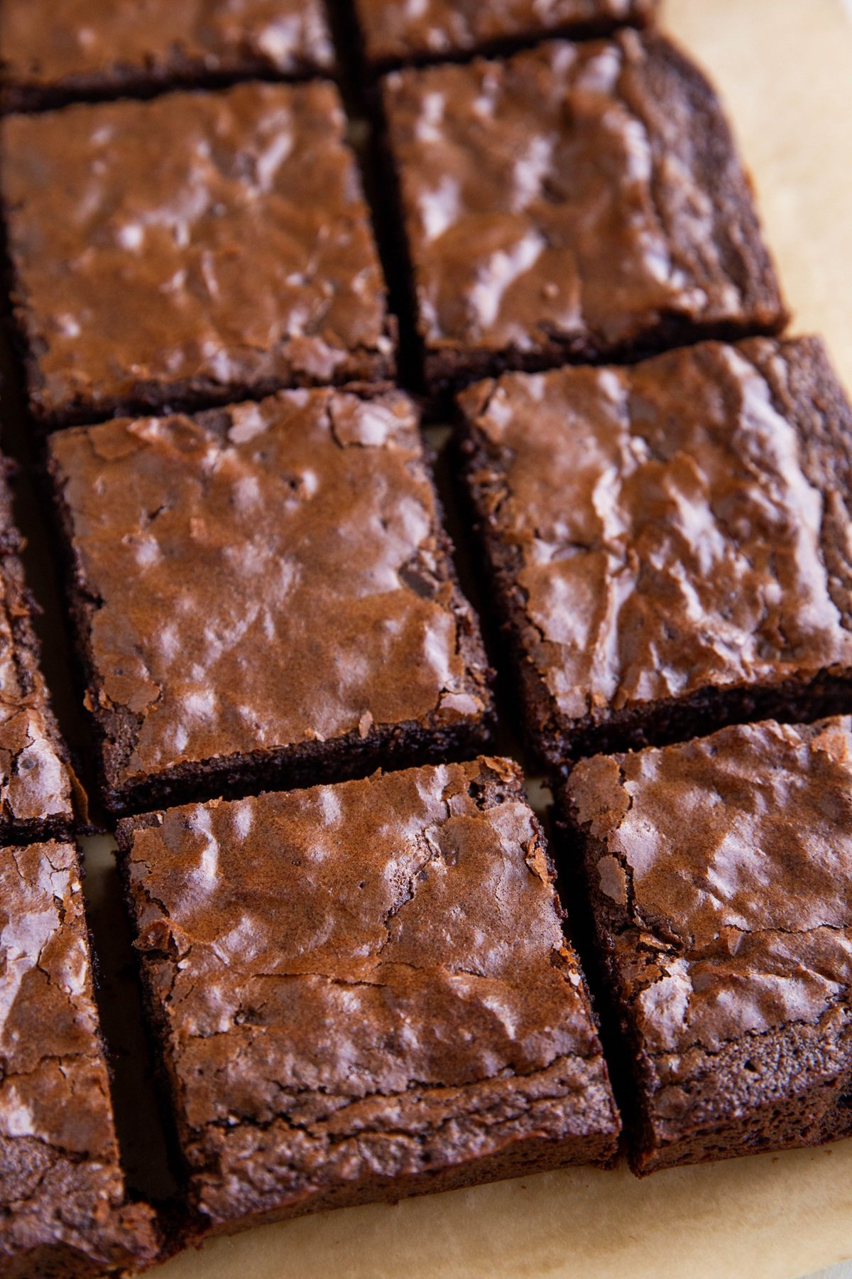 Gluten-free brownies on a sheet of parchment paper, cut into individual slices.
