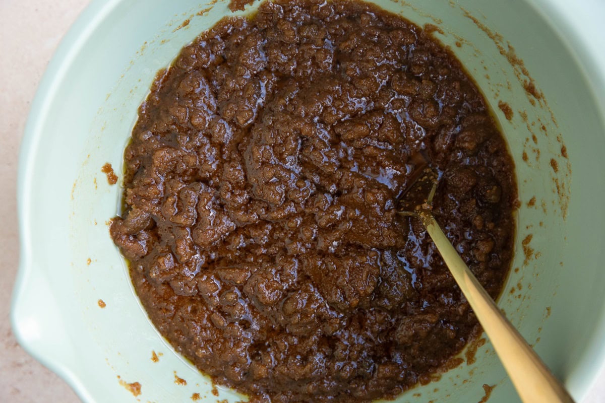 Butter and sugar mixed together in a mixing bowl.