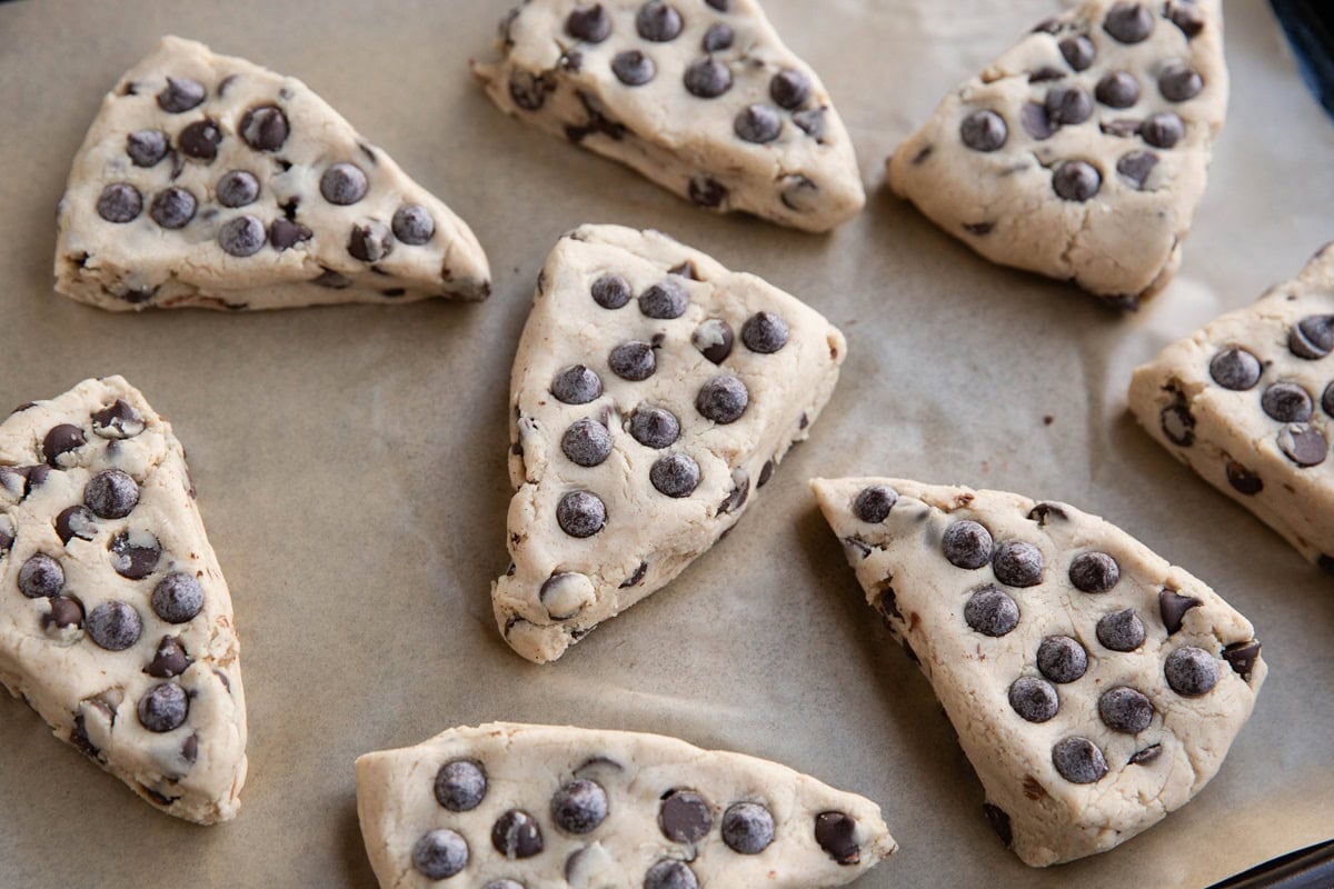 Chocolate chip gluten-free scone dough on a baking sheet, ready to go into the oven.