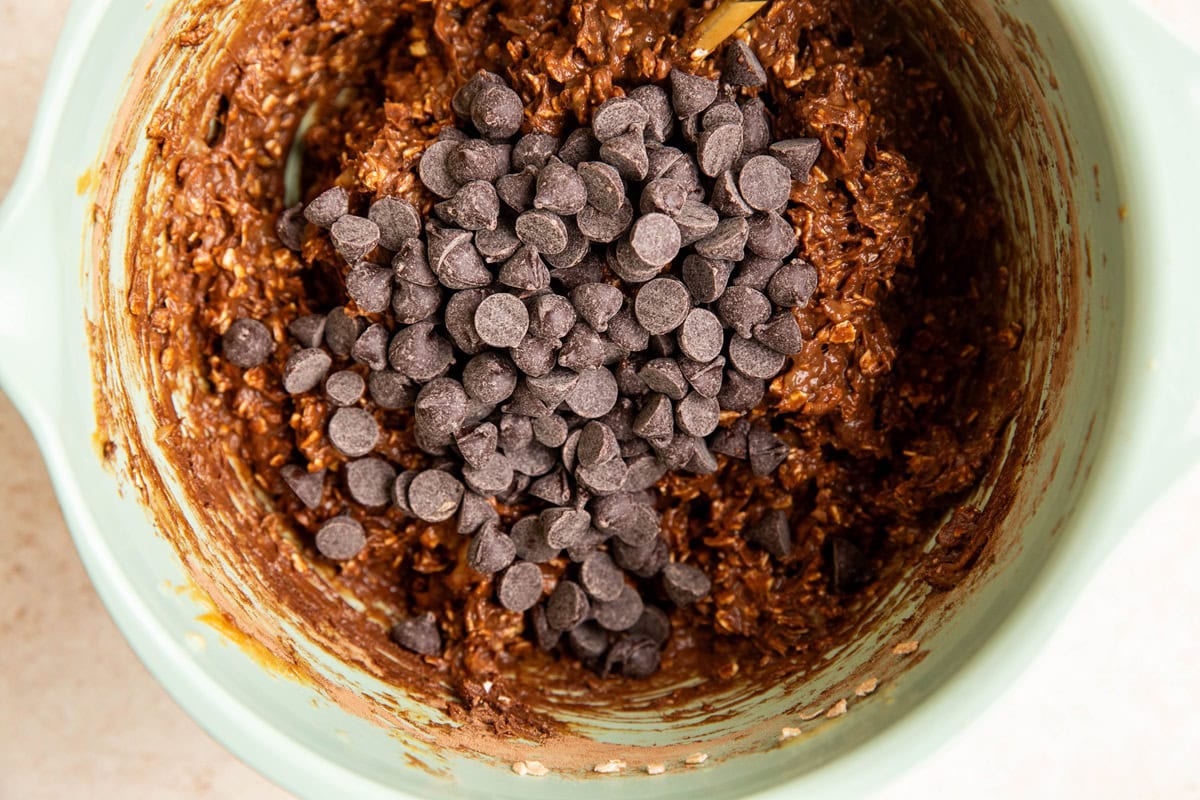 Breakfast bar batter in a mixing bowl with chocolate chips on top.