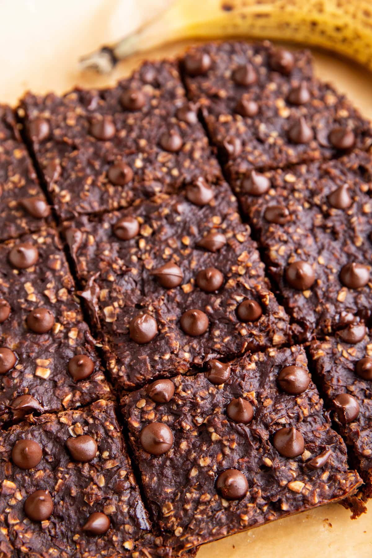 Breakfast bars on a sheet of parchment paper, cut into squares, ready to eat.