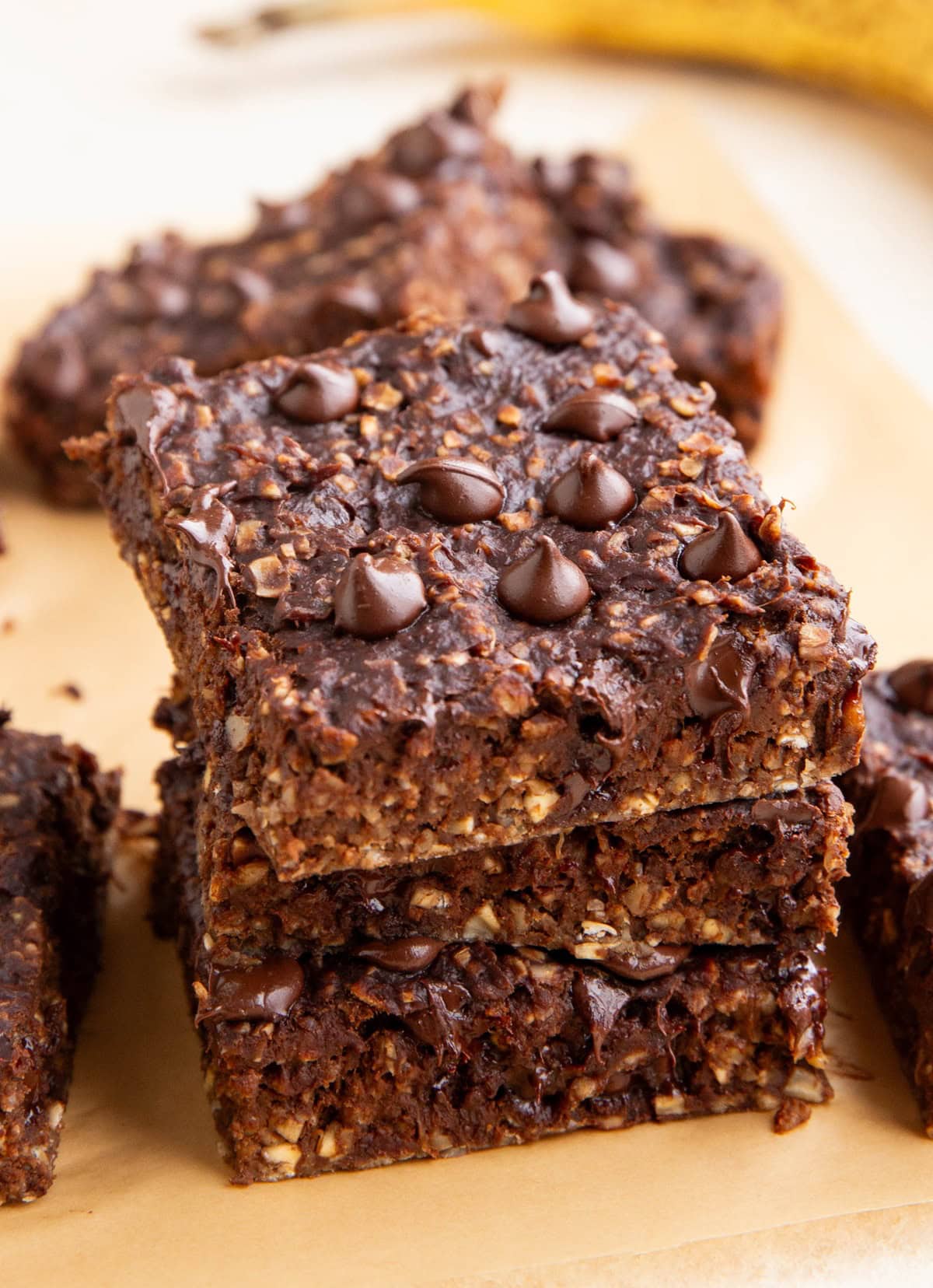 Stack of chocolate oatmeal breakfast bars with more bars in the background.