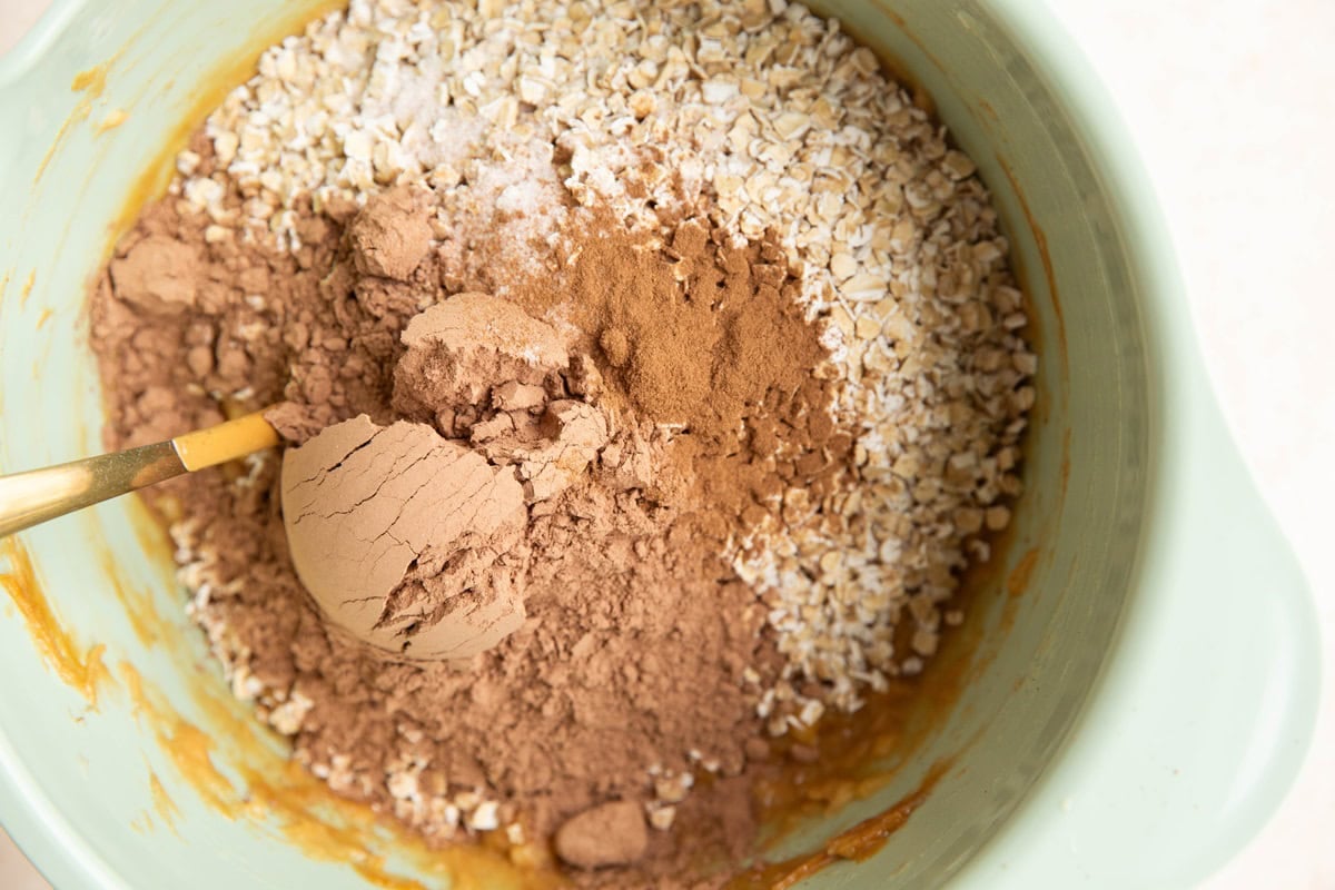 Dry ingredients on top of wet ingredients to make chocolate breakfast bars.