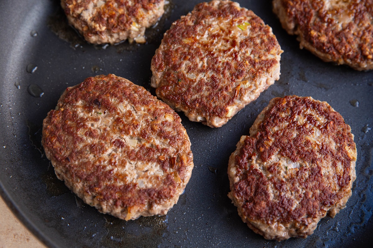 Hamburger meat cooking in a skillet.