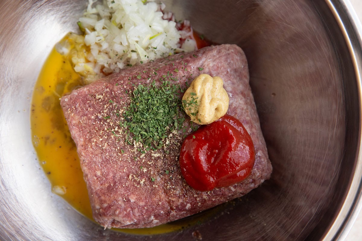 Ingredients for Salisbury steak in a mixing bowl.