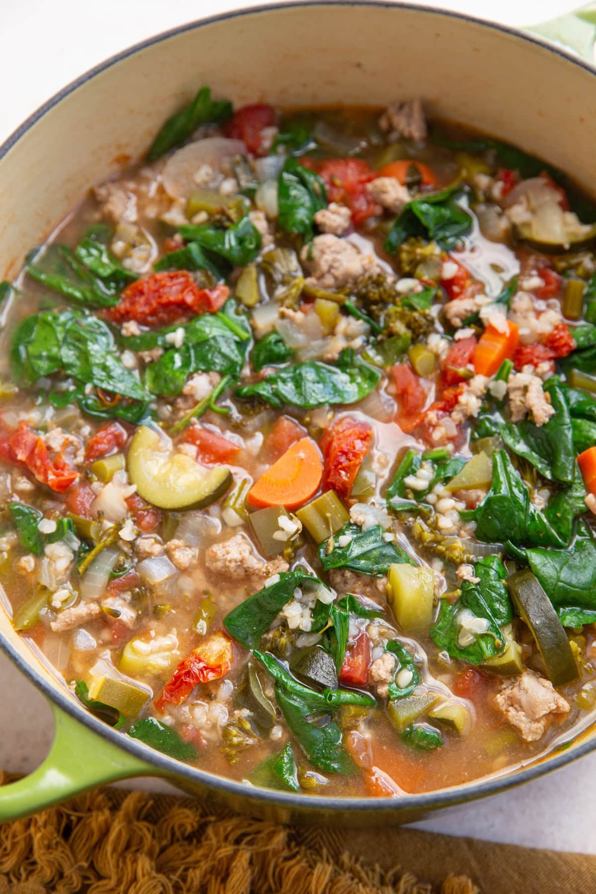 large pot of soup with ground turkey and vegetables, ready to eat.