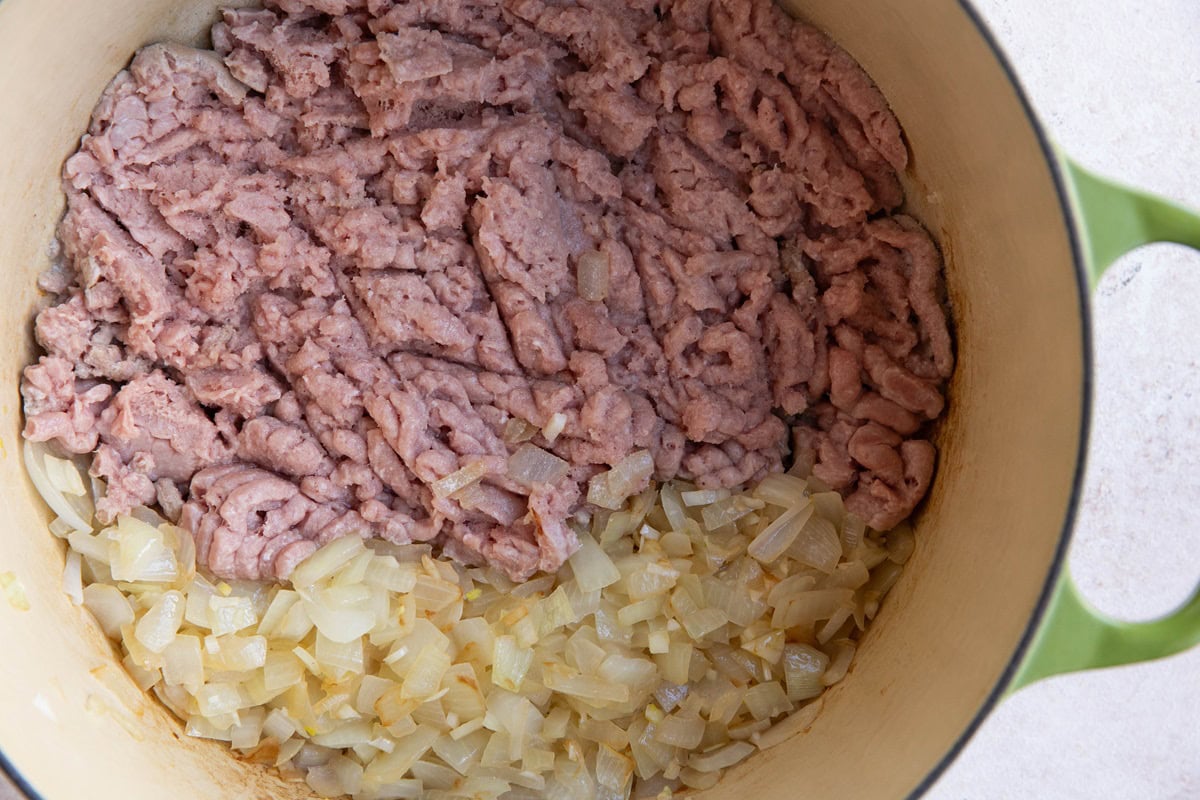 Onion and ground turkey cooking in a large pot.