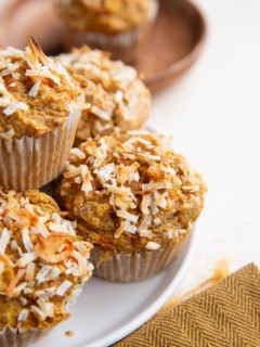 Plate of carrot muffins sprinkled with flaked coconut.