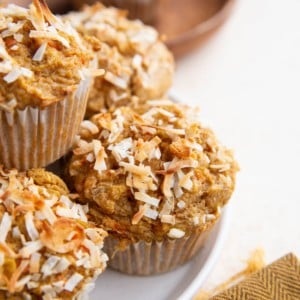 Plate of carrot muffins sprinkled with flaked coconut.