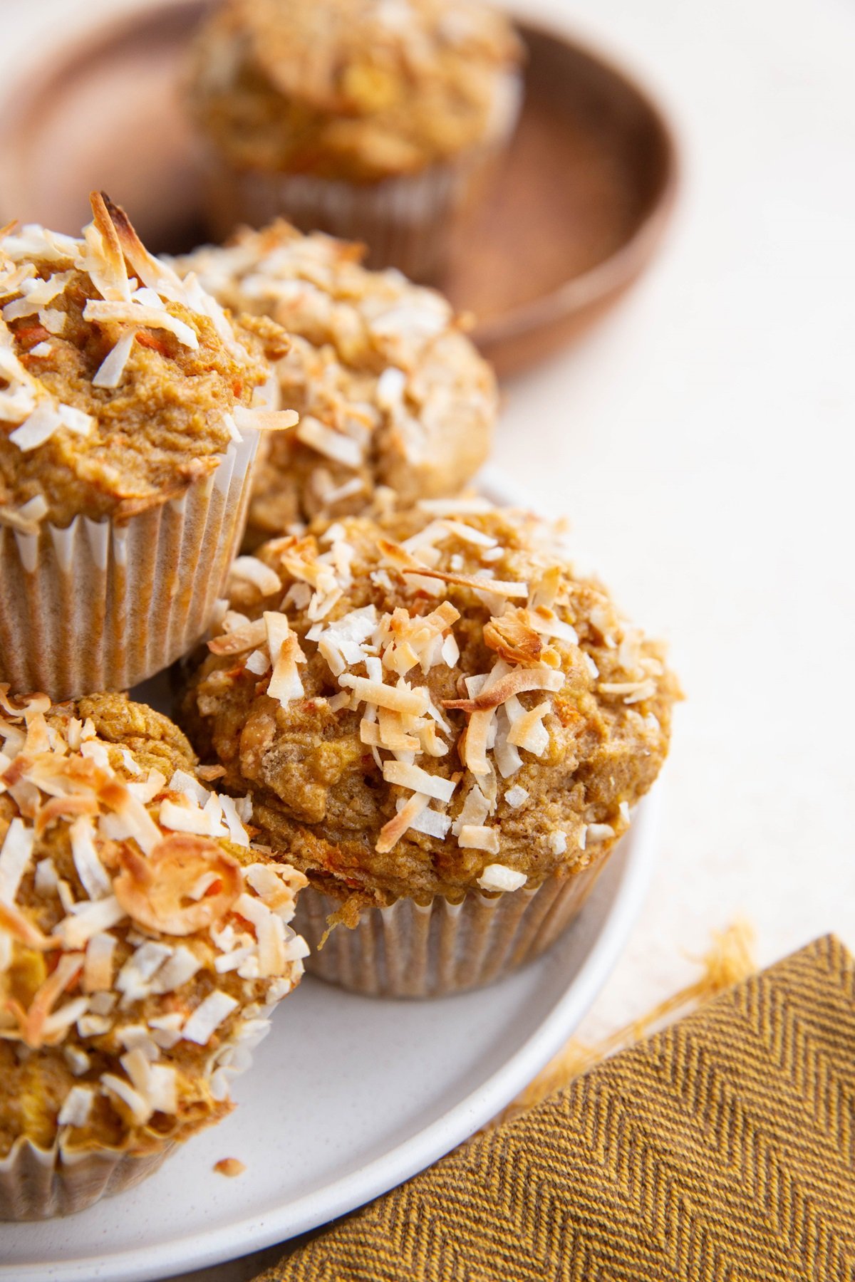 Plate of carrot muffins sprinkled with flaked coconut.