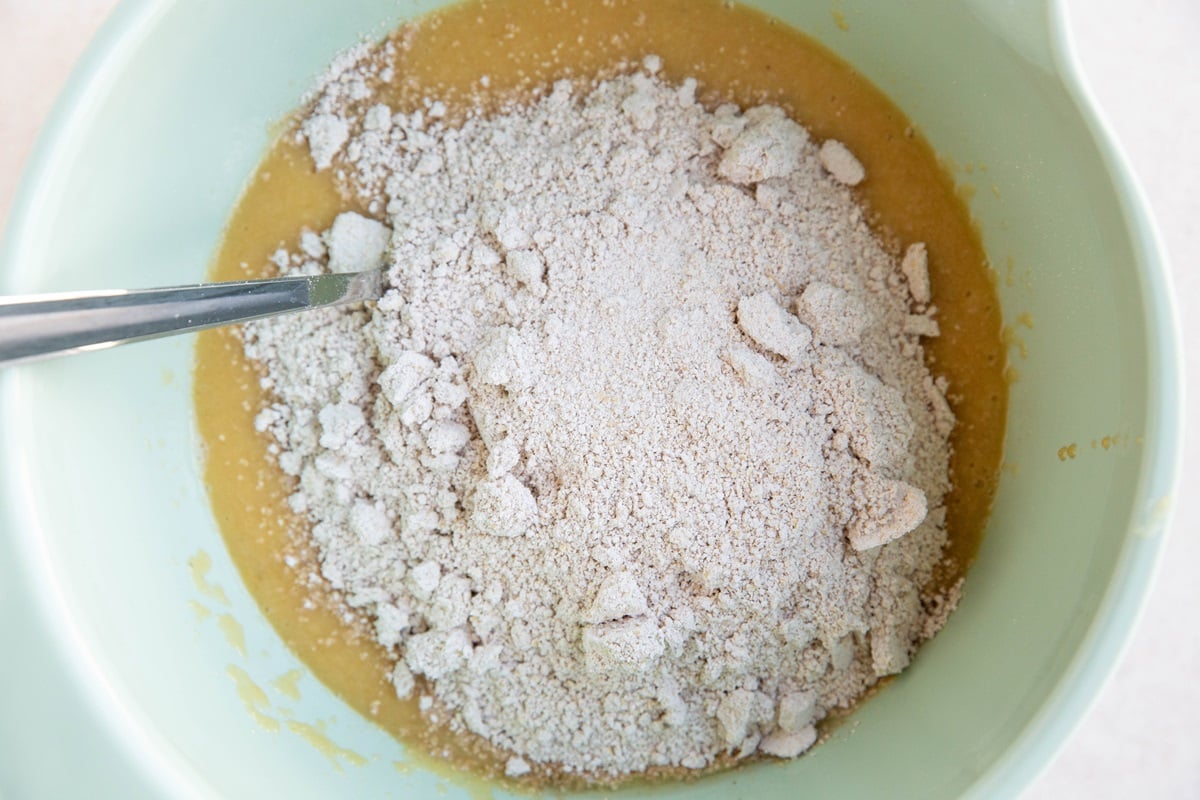 Mixing bowl with wet ingredients with dry ingredients, ready to be mixed in.