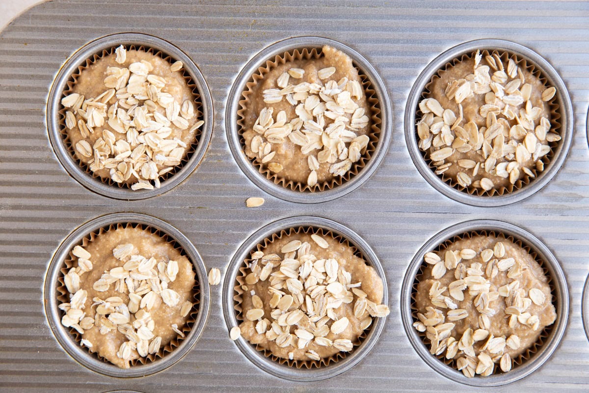 Muffin batter in a muffin tray, ready to go into the oven.